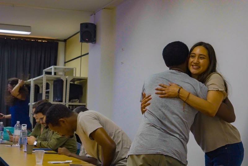 Two Hub researchers from the Ethiopia and Colombia teams embrace in a friendly hug